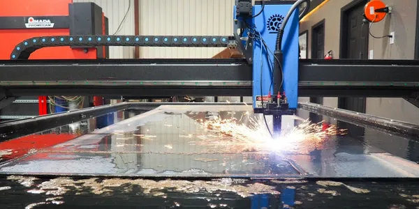 home1 A machine cutting metal with sparks flying out of it.